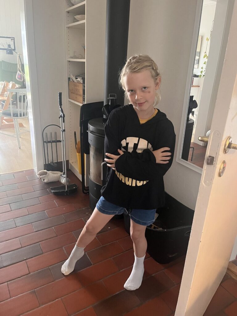 Sort hættetrøje med tekst “stay magical”